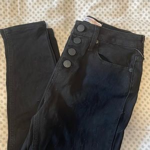 Black skinny jeans never worn but ripped tags off before realizing their size